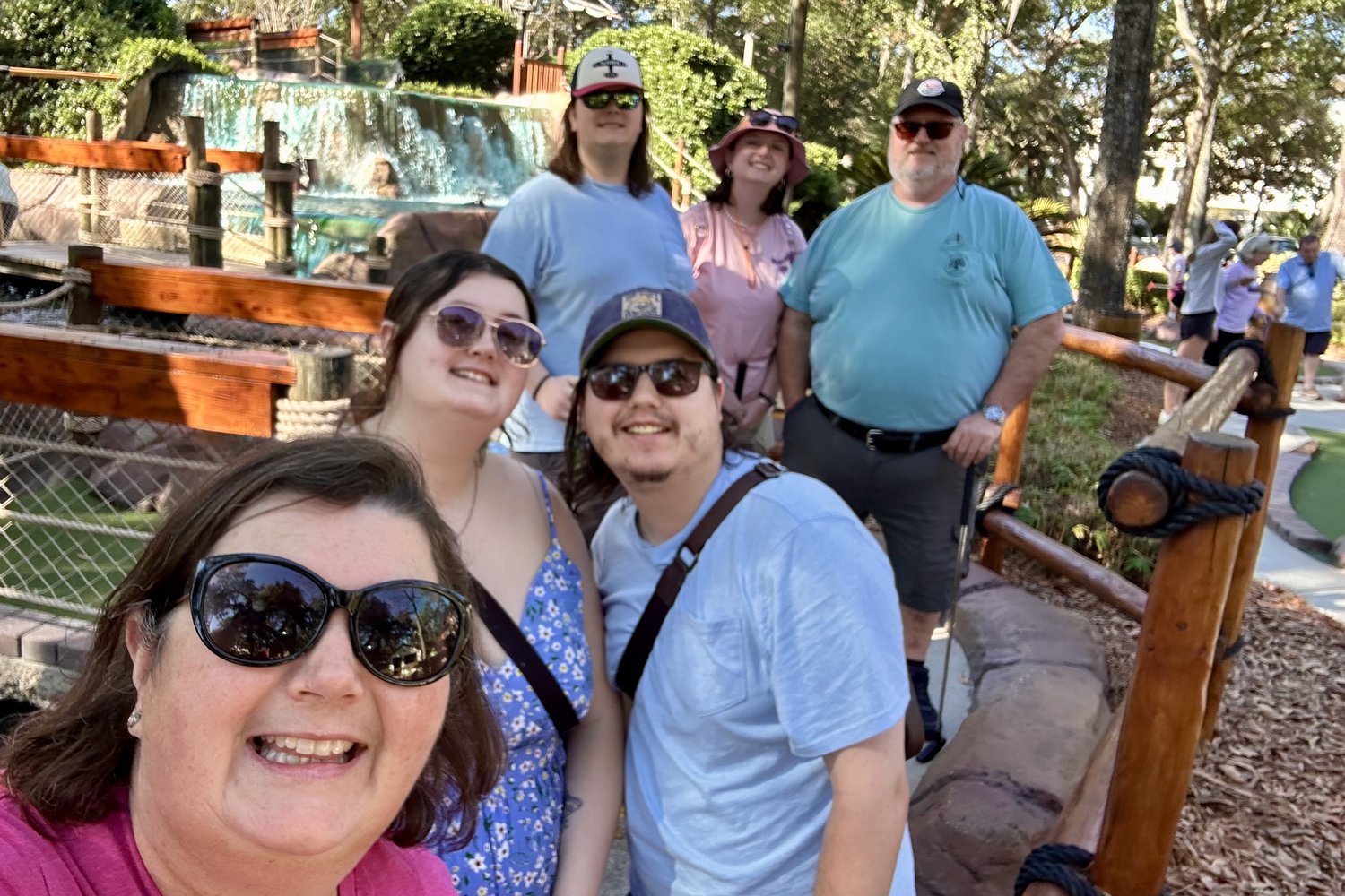 The Woodward family, owners of Two Fish Vending, smiling together outdoors on a sunny day